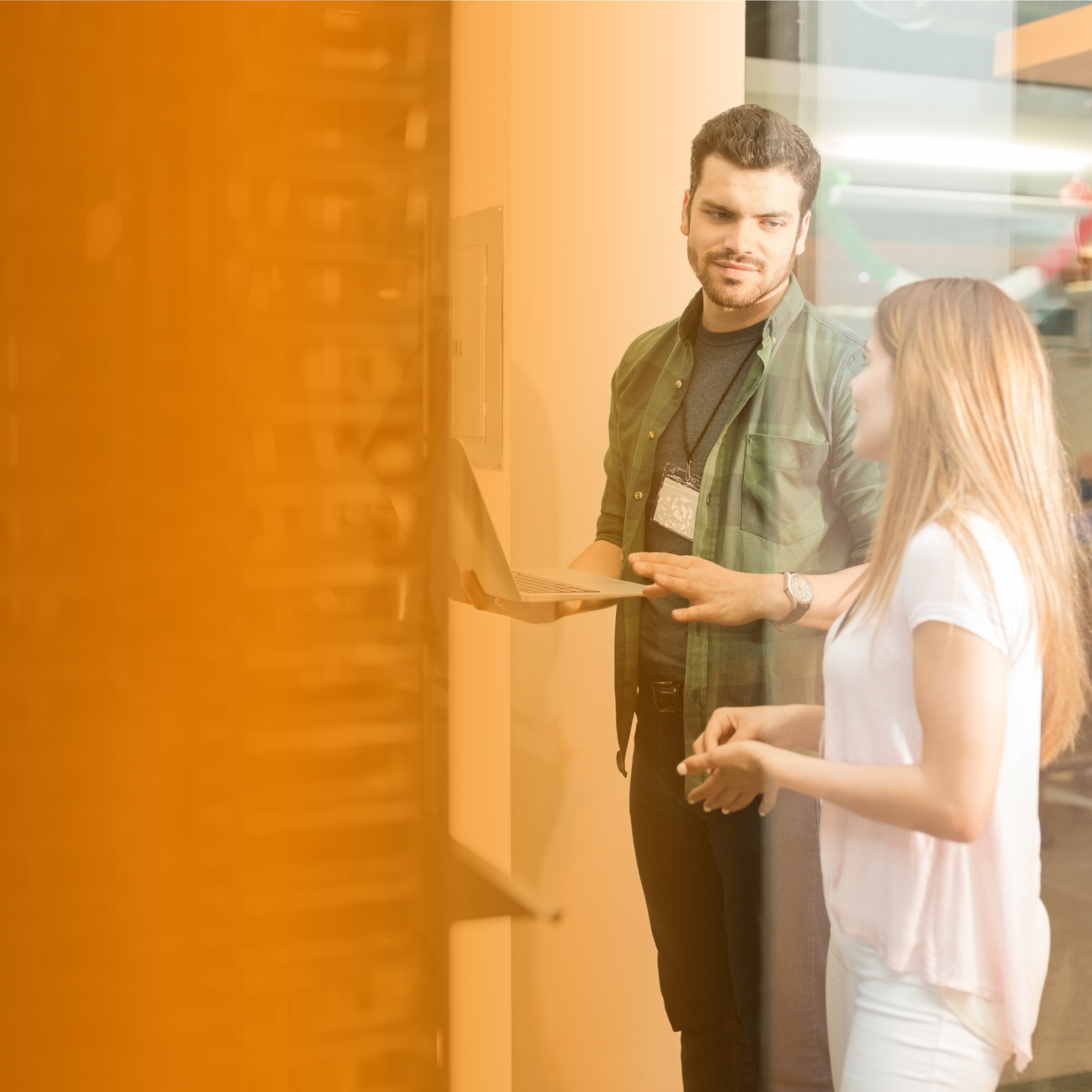 Two business people talking besides a rack