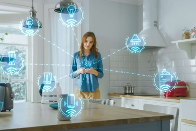 Woman in kitchen with IoT features