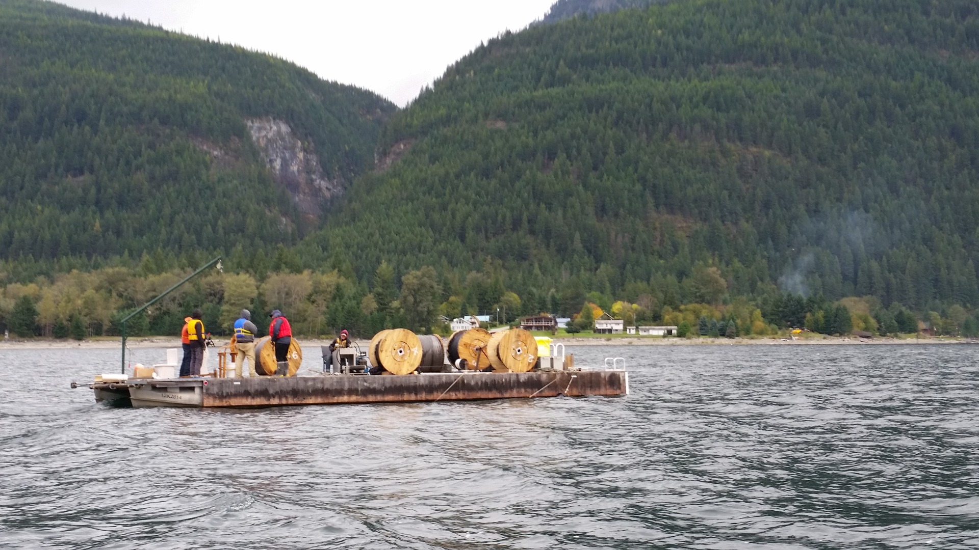 People in boat mounting fiber