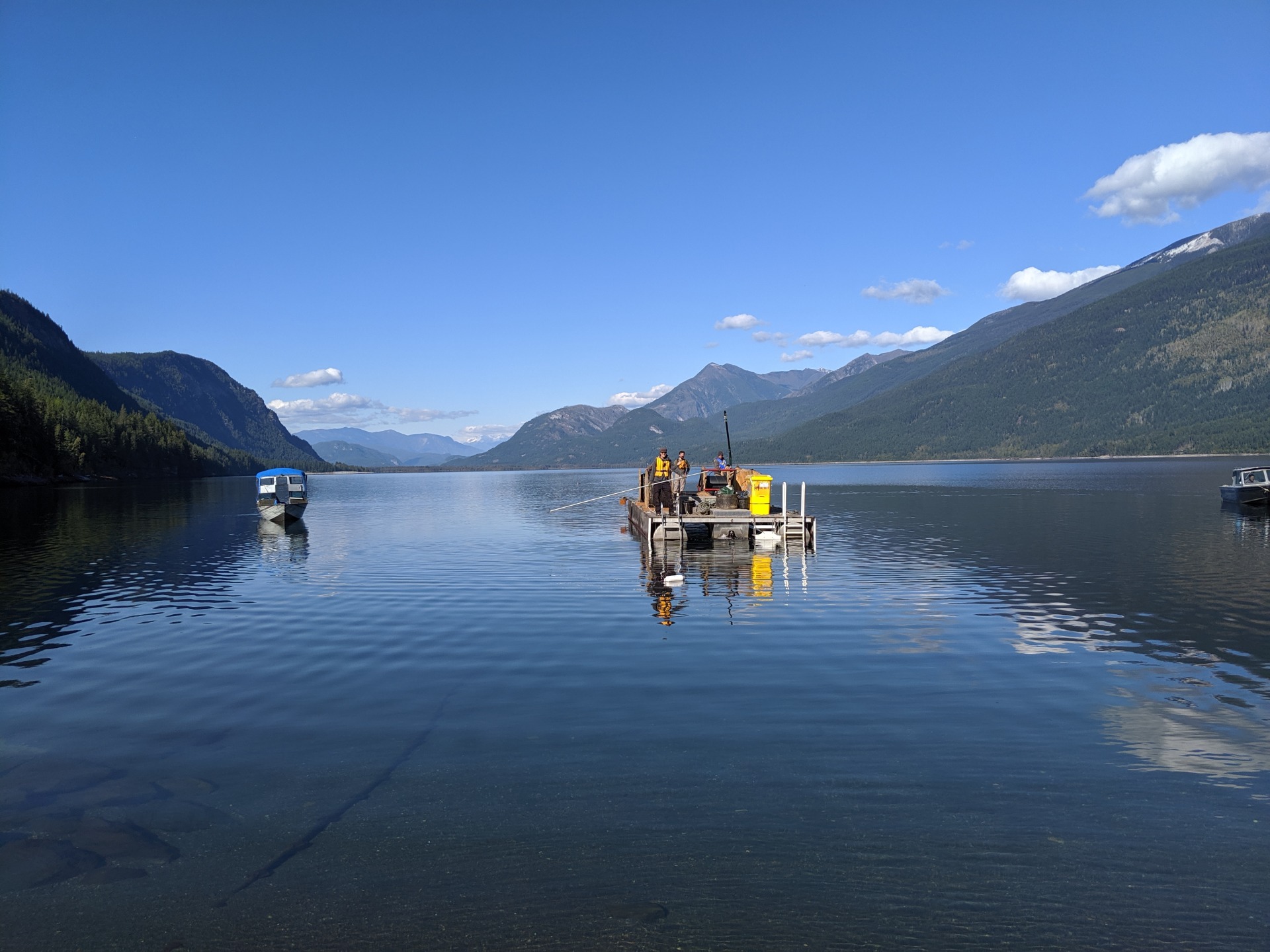 People on boat in lake, bringing fiber
